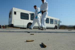 Bullet shells on the ground as members of the FBI practice their investigation techniques