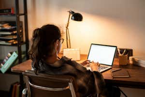 Teen girl doing homework on her laptop; Shutterstock ID 1251579397; purchase_order: -; job: -; client: -; other: -