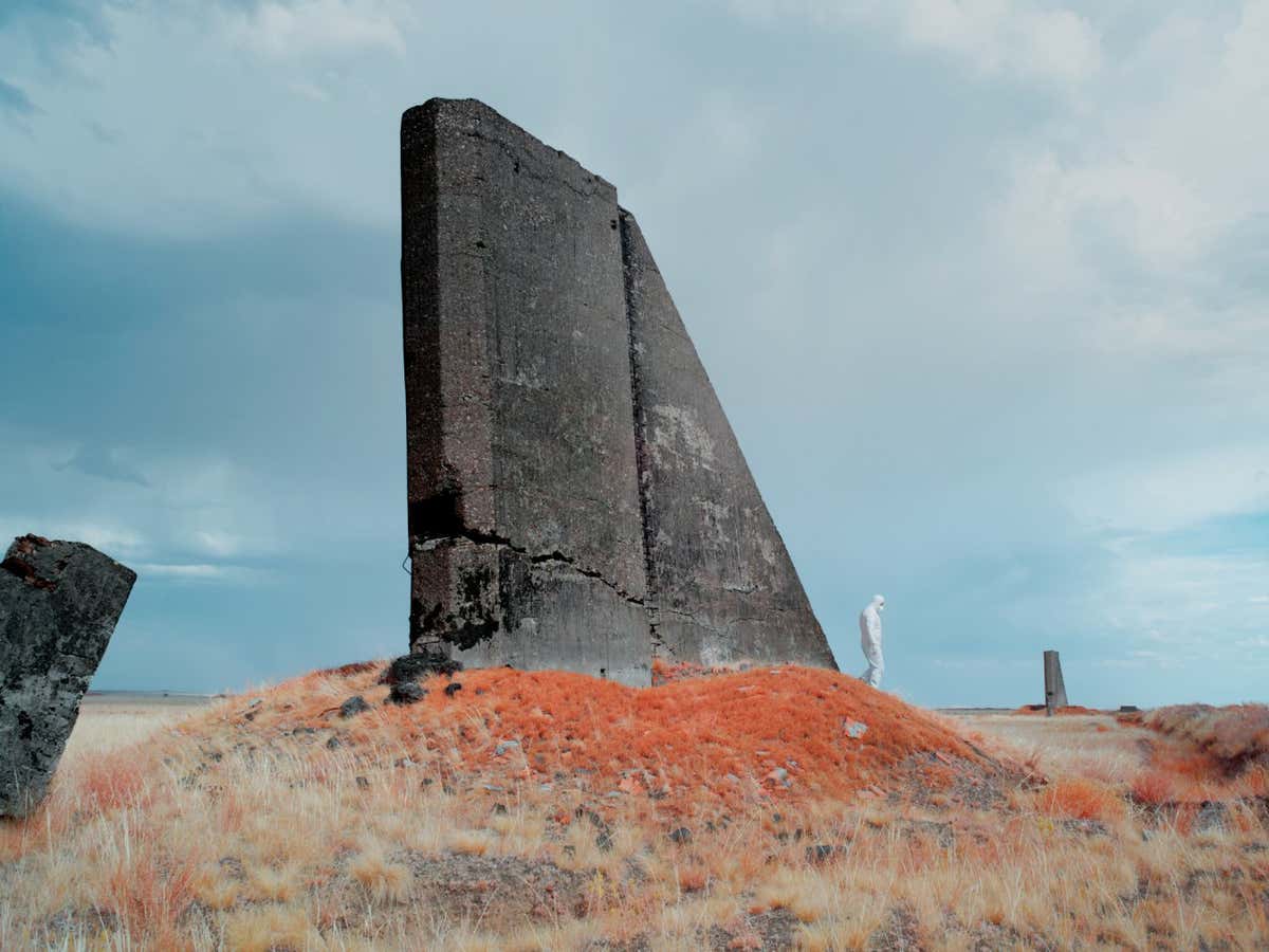 Eddo Hartmann is a finalist in the Professional Competition of the Sony World Photography Awards 2024, exhibition at Somerset House, London, 19 April-6 May 2024 worldphoto.org/ Photographer Name: Eddo Hartmann Image Name: Untitled Year: 2024 Image Description: An infrared image of the remains of an observation tower at Opytnoe Pole. This was the first testing ground at the Semipalatinsk Test Site, which was a large-scale facility used between 1949 and 1962 for atmospheric nuclear tests. Series Name: The Sacrifice Zone Series Description: This series explores a remote area of Kazakhstan known as ?The Polygon?, which was once home to the Soviet Union?s major nuclear testing facilities. Between 1949 and 1989 more than 450 nuclear tests took place here, with little regard for their effect on the local people and environment. The full impact of radiation exposure was hidden for many years by the Soviet authorities and only became clear after the test site was closed in the early 1990s. The location is still heavily contaminated and can only be accessed in protective clothing. The images in this series were made using an infrared camera, which hints at a menace that is equally invisible to the human eye: the radiation resulting from the nuclear explosions. Plants that have absorbed radiation acquire a strange reddish-purple colour, which is how their toxicity ? invisible to the naked eye ? is revealed. Copyright: ? Eddo Hartmann, Netherlands, Finalist, Professional competition, Landscape, Sony World Photography Awards 2024